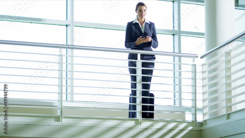 Wallpaper Mural Caucasian businesswoman using smart phone  Torontodigital.ca