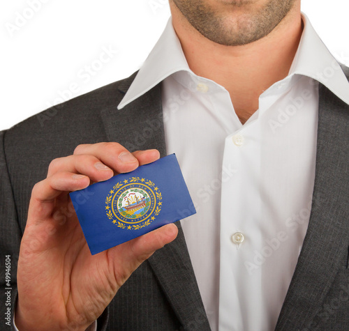 Businessman is holding a business card, New Hampshire photo