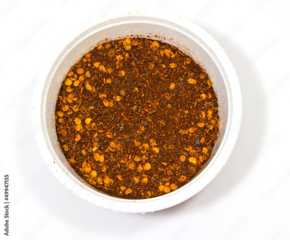 Paprika ground in a white bowl on white background. Paprika ground in a white bowl on white background.