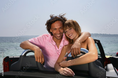 Happy couple in a convertible car