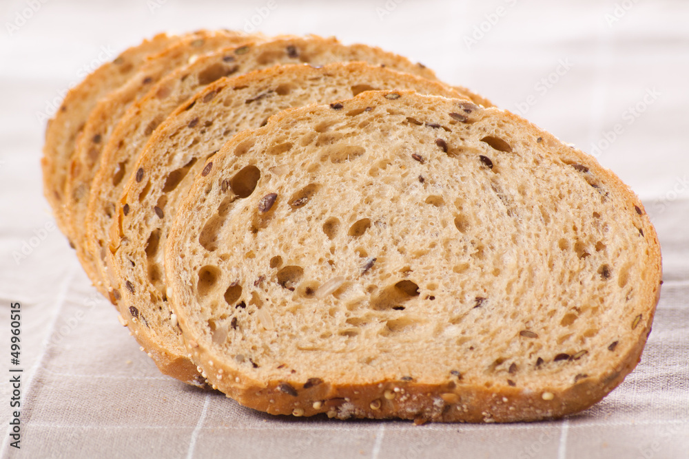 Healthy whole grain sliced bread with sunflower seeds on brown n Healthy whole grain sliced bread with sunflower seeds on brown n