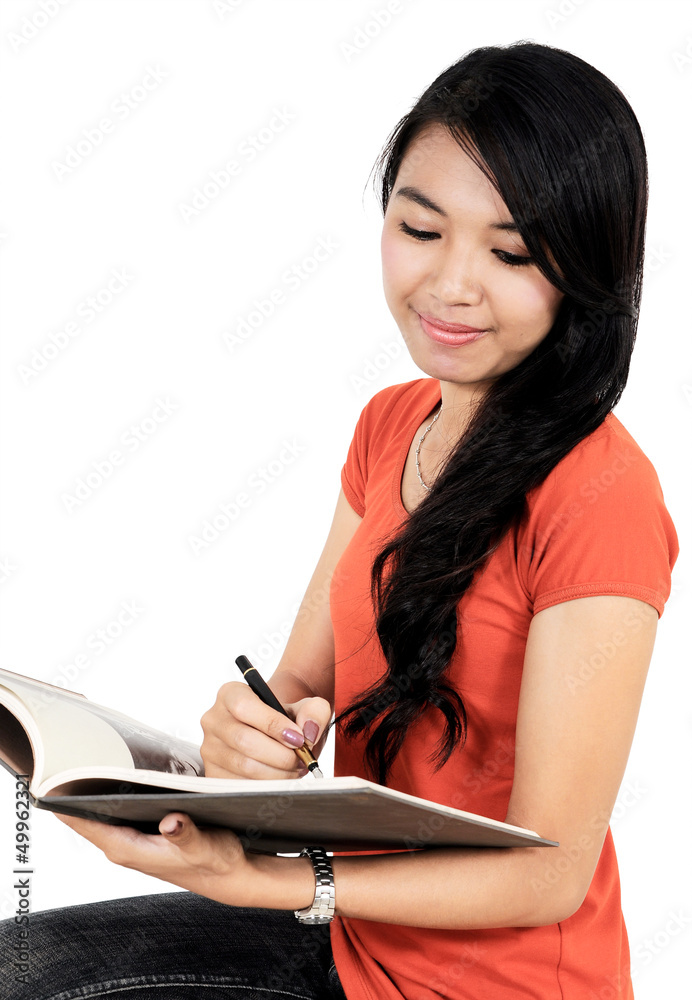 Beautiful girl writes pencil to writing-books Beautiful girl writes pencil to writing-books