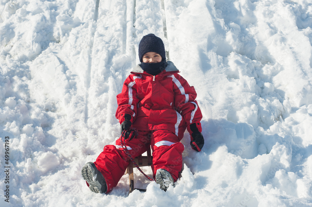 Kid sliding with sled in the snow. Kid sliding with sled in the snow.