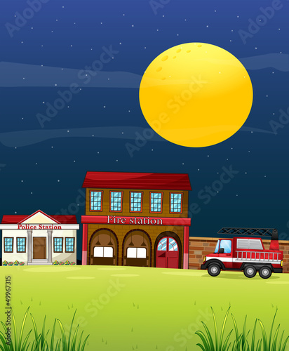 A police station beside the fire station with a fire truck