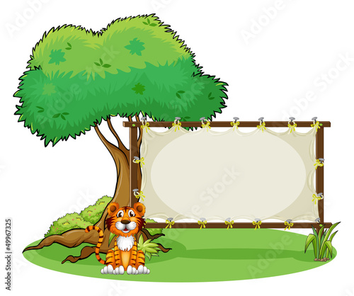 A tiger beside a rectangular signage