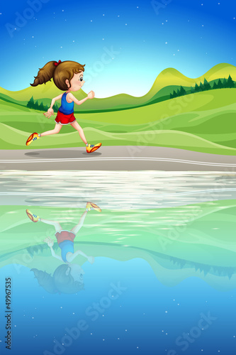 A girl running along the river