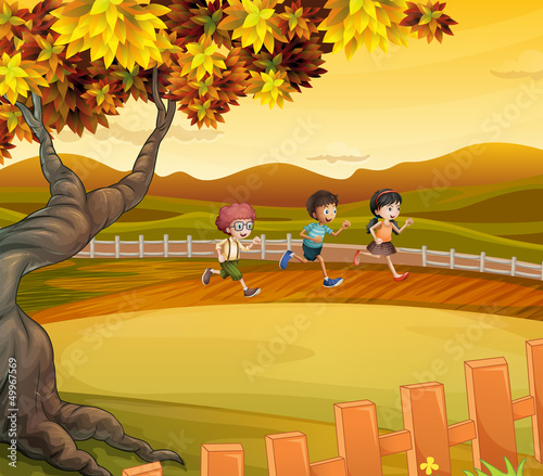 Three kids running along the field