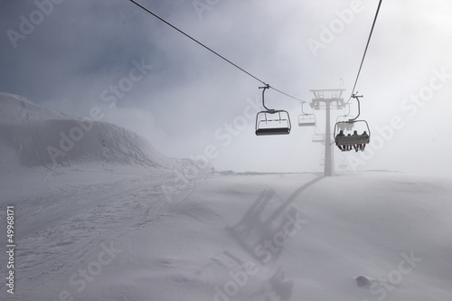 Ski chairlift on foggy day photo