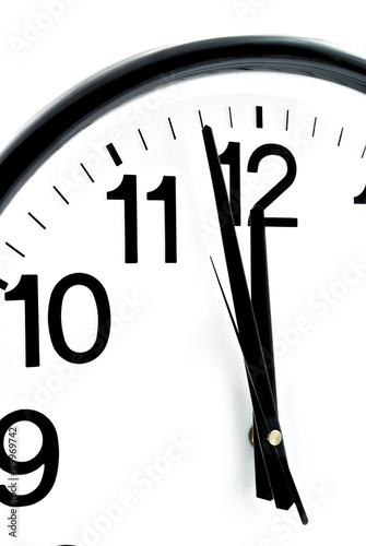 Black wall clock, two minutes to twelve