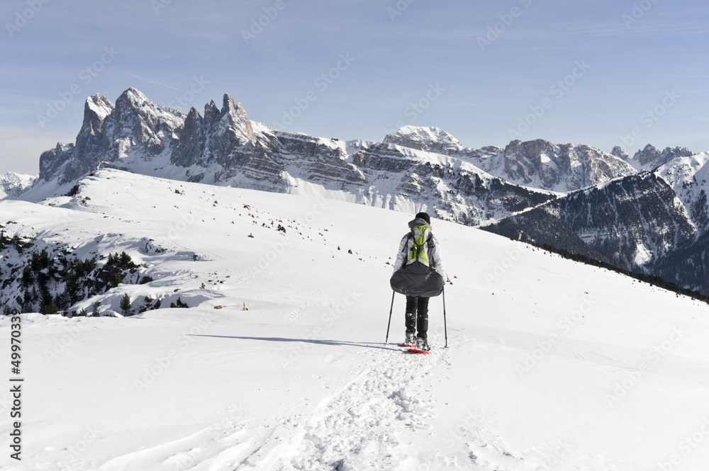 Girl is snowshoeing at High Altitude in the Alps