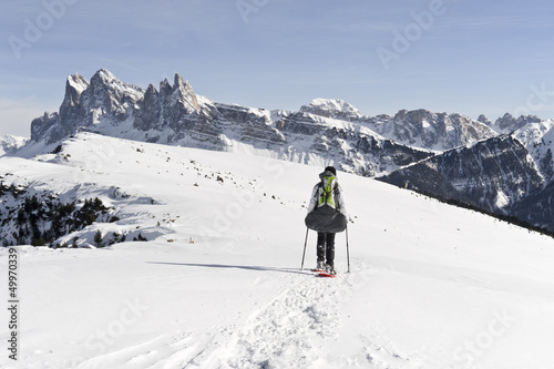 Girl is snowshoeing at High Altitude in the Alps