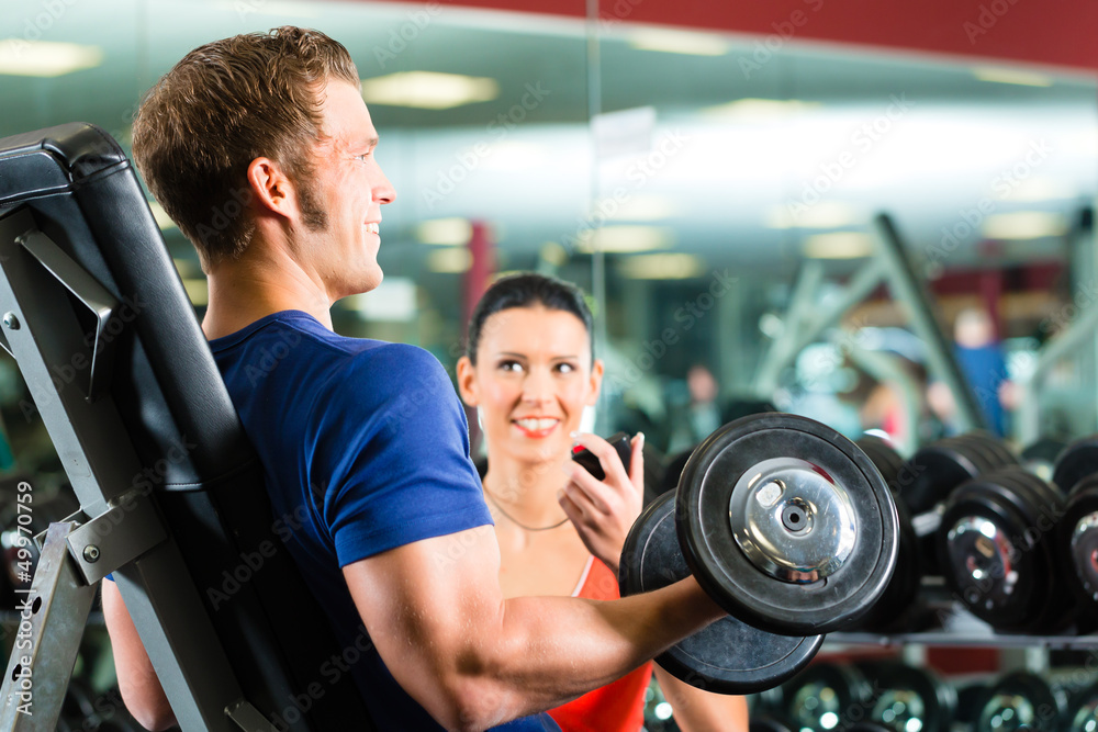 Personal Trainer in gym and dumbbell training Personal Trainer in gym and dumbbell training