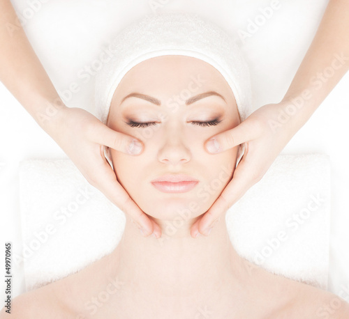 Portrait of a young woman laying on a head massage procedure