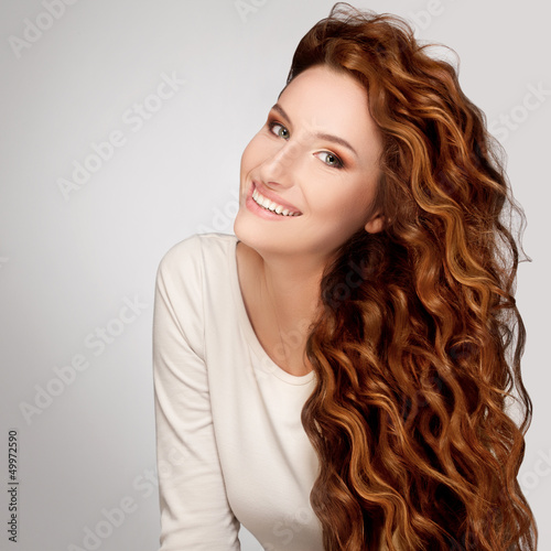 Red Hair. Woman with Beautiful Curly Hair photo