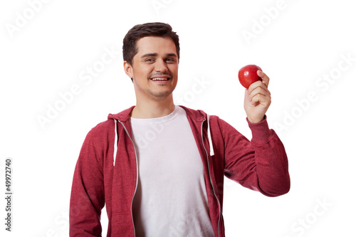 Young man in white shirt and with red apple