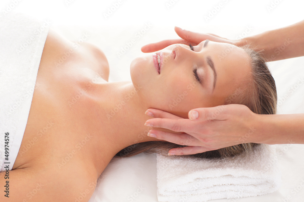 A young blond woman relaxing on a spa massage procedure