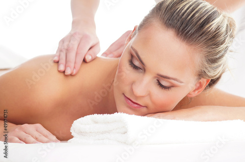 Portrait of a young woman on a back massage procedure