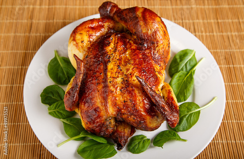 Roast Chicken on Plate Garnished with Spinach Leaves
