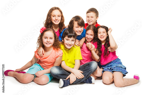Group of happy kids sitting together