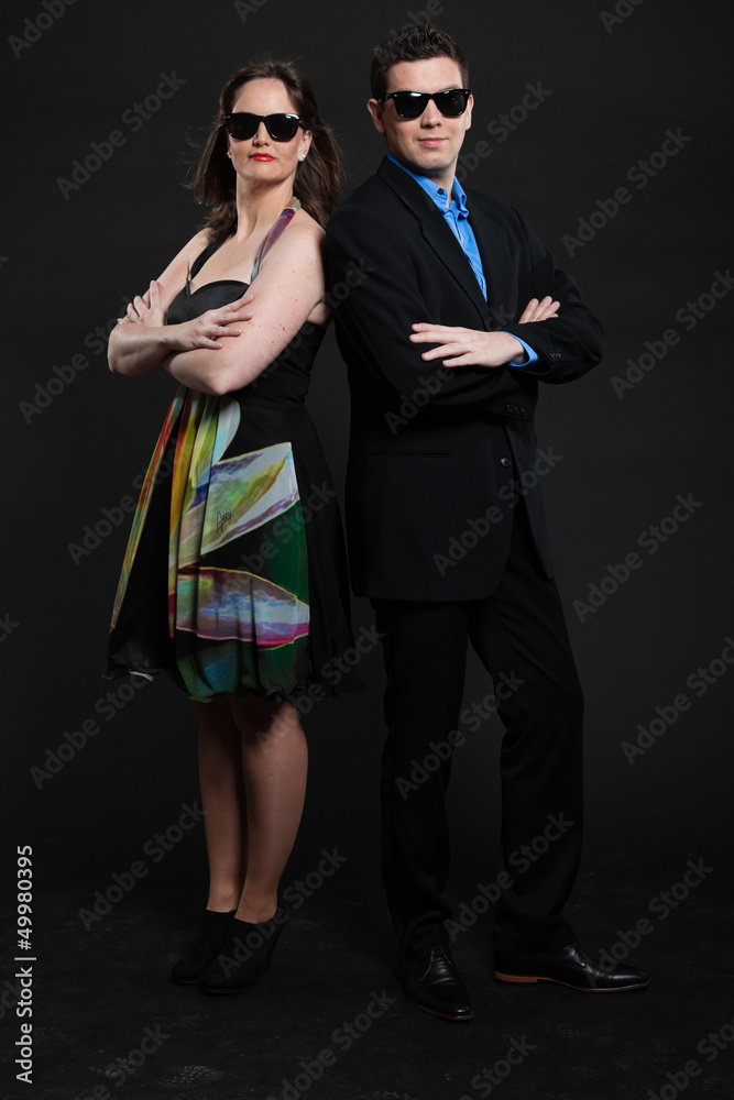 Happy young couple with black sunglasses. Studio shot. Happy young couple with black sunglasses. Studio shot.