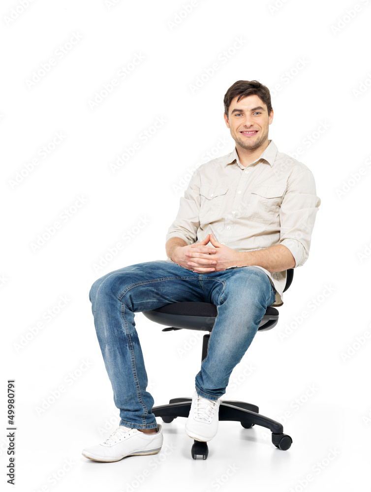 Portrait of smiling happy man sits on office chair Portrait of smiling happy man sits on office chair