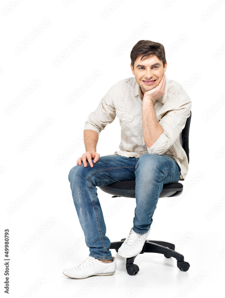 Portrait of smiling happy man sits on office chair Portrait of smiling happy man sits on office chair