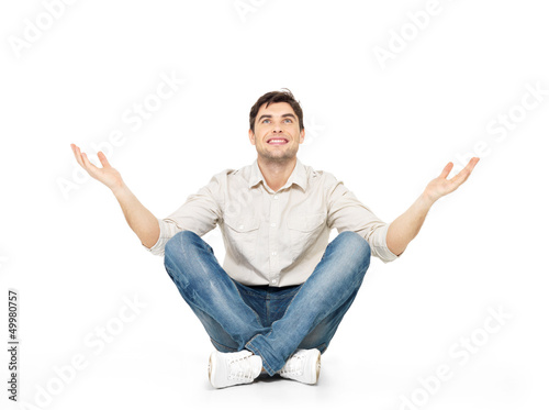 Sitting happy man with raised hands up