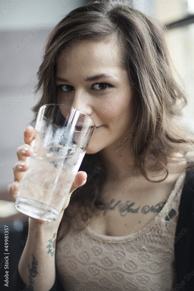 Young Woman Drinking a Pint Glass of Ice Water Young Woman Drinking a Pint Glass of Ice Water