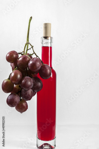 Red Grapes and wine bottle