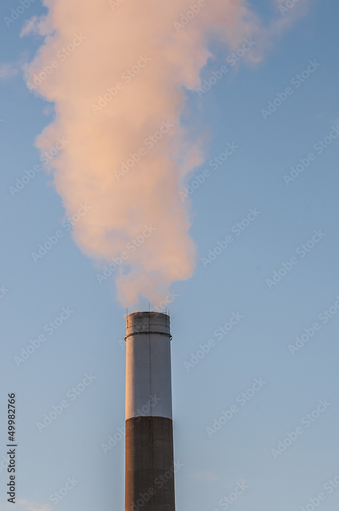 smoking chimnney stack in blue sky