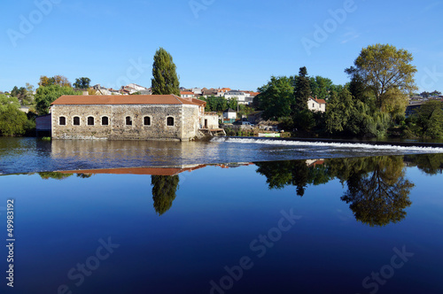 Old tannery with a dam along the Vienne river in Saint-Junien, Limousin, France photo