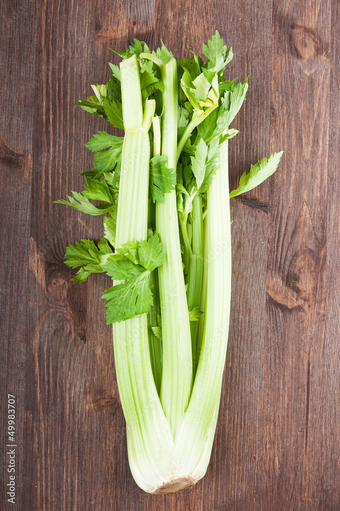 Bunch celery on the dark wooden background Bunch celery on the dark wooden background