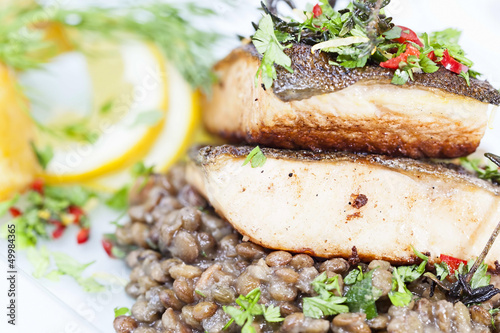 Baked salvenius filet on lentil salad photo