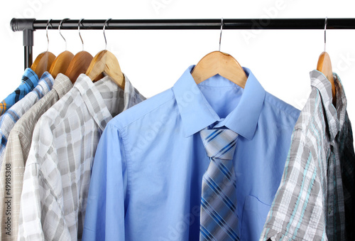 Shirts with ties on wooden hangers isolated on white