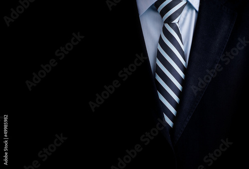 Canvas Print Black business suit with a tie and copyspace background