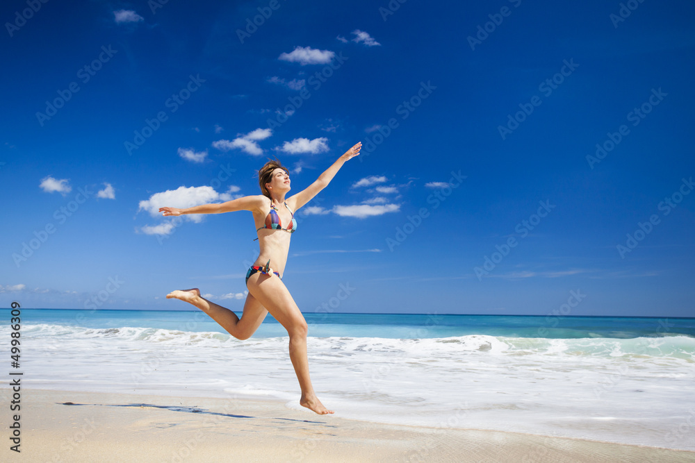 Woman jumping on the beach Woman jumping on the beach