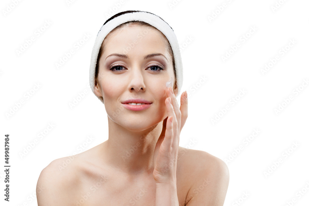 Woman with headband making face moisturizing procedures Woman with headband making face moisturizing procedures