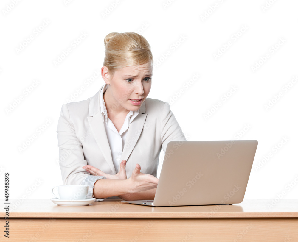 Attractive business woman sitting at a desk with laptop Attractive business woman sitting at a desk with laptop