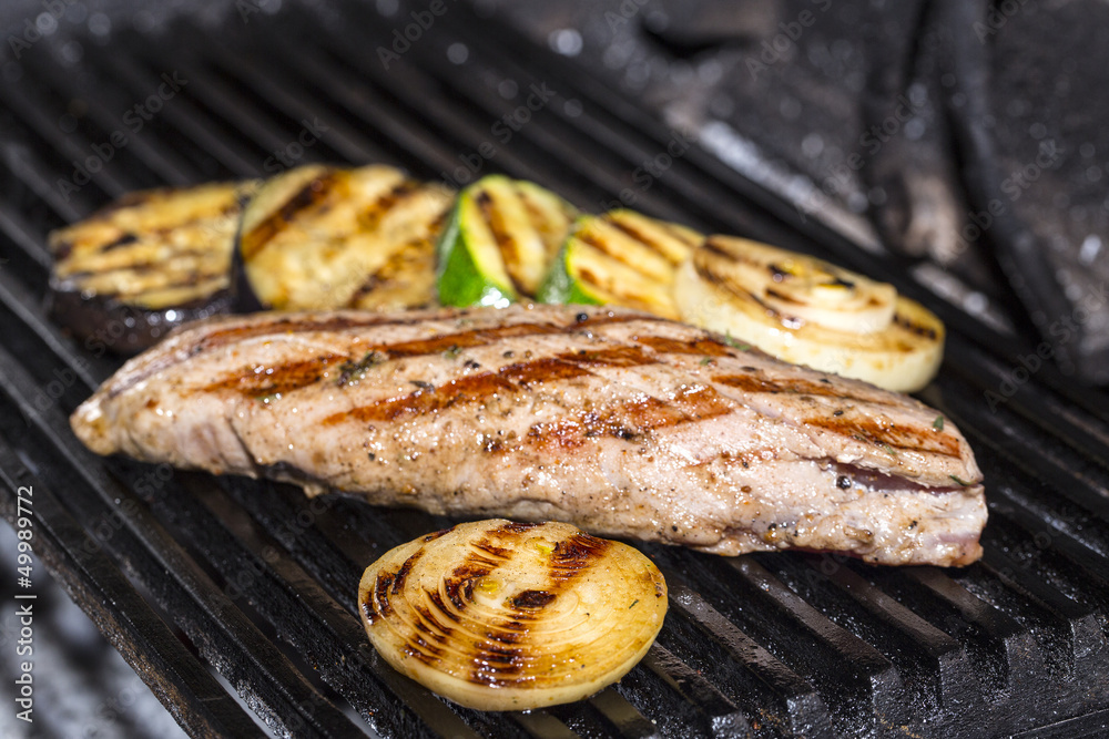 cooking beef steak on a grill in the restaurant cooking beef steak on a grill in the restaurant