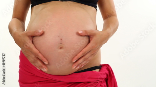 pregnant woman heart shape on belly photo