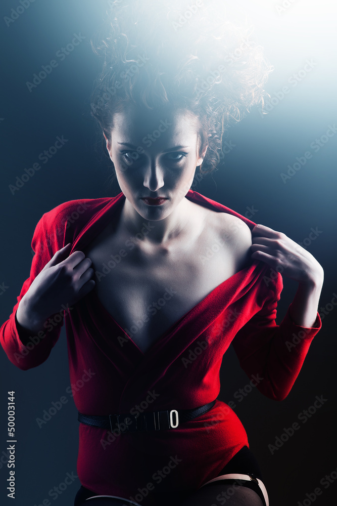 Flirting woman in red with curly hairstyle