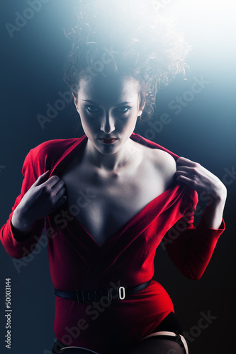 Flirting woman in red with curly hairstyle