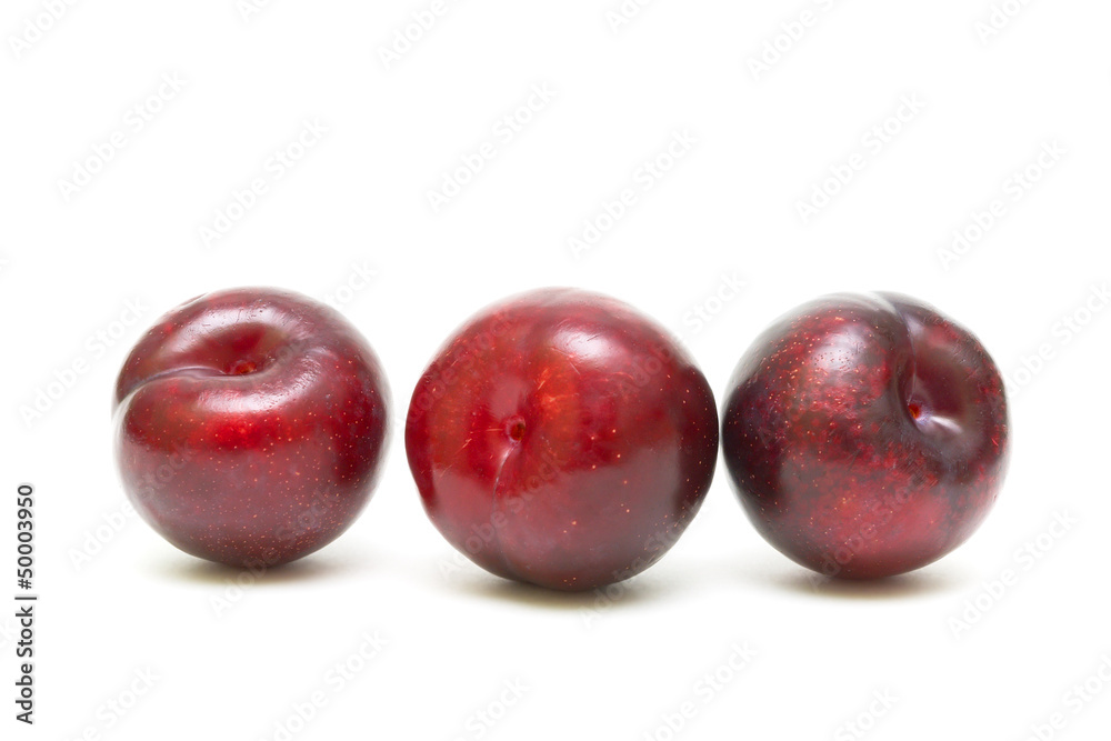 plums close-up on white background