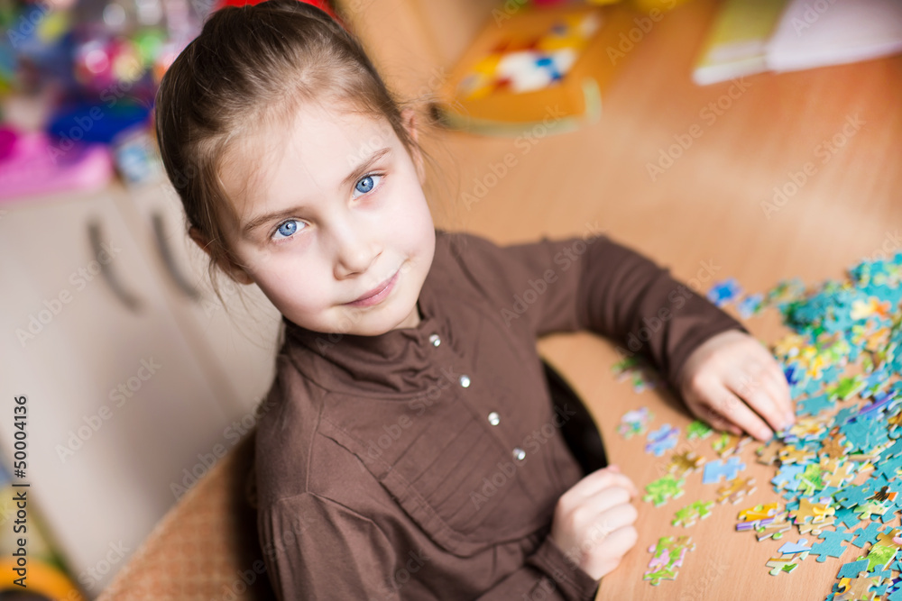 Cute little girl solving puzzles Cute little girl solving puzzles