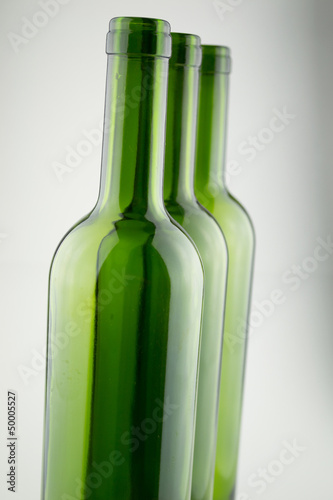 empty green wine bottles isolated on white