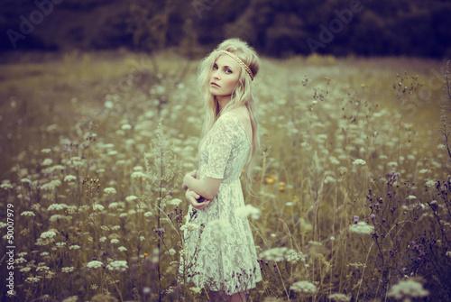 beautiful young girl in a summer field