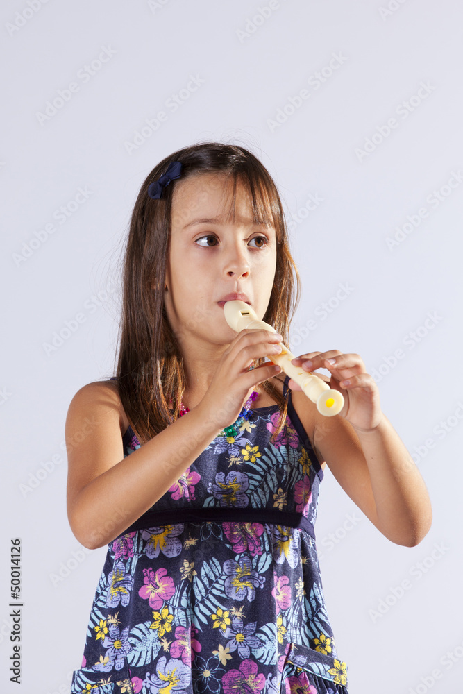 Little girl playing flute