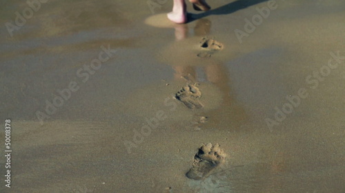 Footprints on the beach left behind, , slow motion shot at 480fp