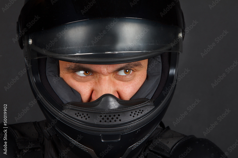 Biker in a helmet with a aggressive facial expression Biker in a helmet with a aggressive facial expression
