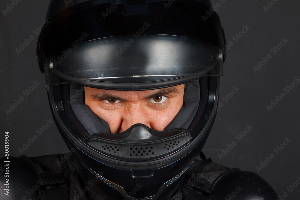 Man in bikers helmet with a defiant facial expression